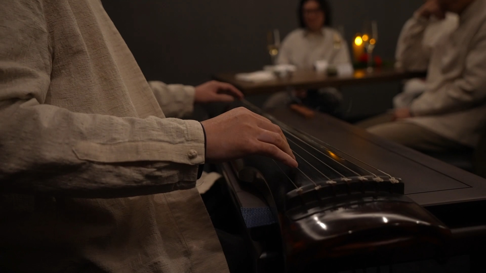 Playing guqin close‑up