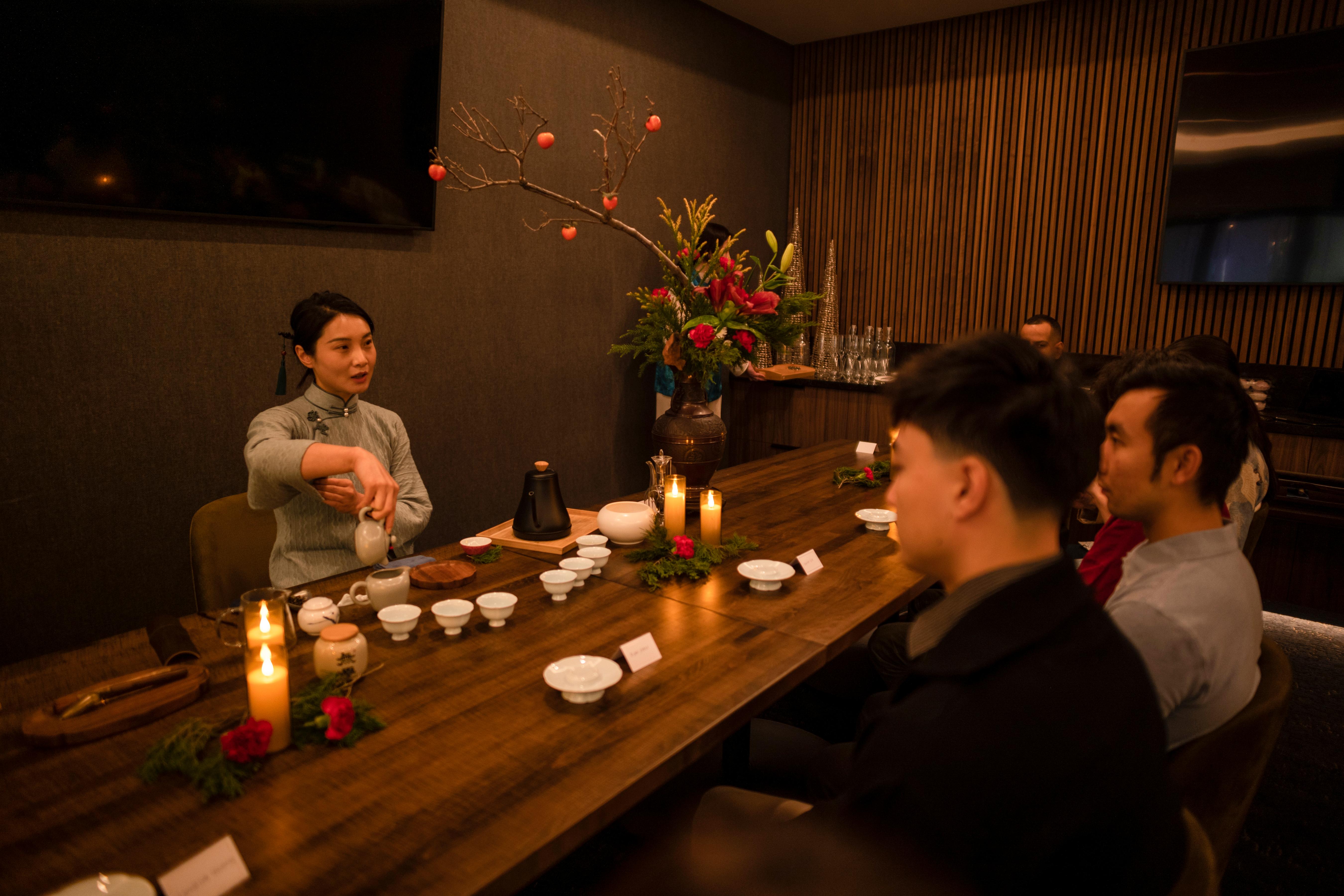 Adults practicing calligraphy together